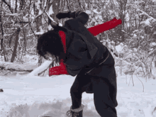 a person wearing a red scarf standing in the snow