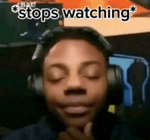 a man wearing headphones with his eyes closed and the words `` stops watching '' written on the bottom .