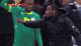 a man in a black jacket with the word caf on the front