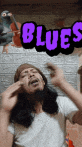 a man is covering his ears in front of a poster that says blues