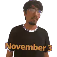 a man wearing glasses and a black shirt that says november 3 giving a thumbs up