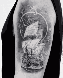 a black and white tattoo of a sailing ship