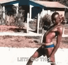 a woman in a bikini is dancing in front of a house and says lets do this