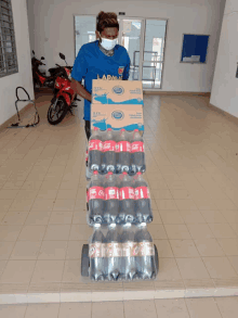 a man wearing a face mask is carrying a stack of coca cola bottles