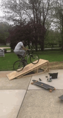 a man is riding a bike down a ramp with a sign in the background that says ' affordable homes '