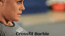 a close up of a woman 's face with the words `` crossfit barbie '' on the bottom .