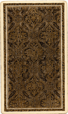 the back of a playing card with a floral pattern on it