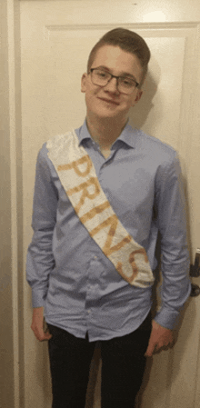 a young man wears a sash that says prins