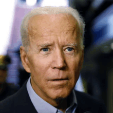 a close up of a man 's face with a serious look