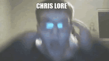 a man is talking on a cell phone with his eyes glowing in the dark and the words `` chris lore '' above him .