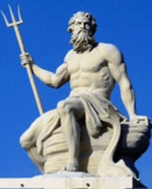 a statue of a man holding a trident in his right hand