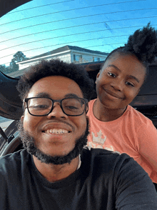 a man and a girl are posing for a picture in a car