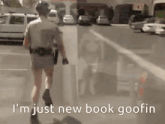 a police officer walking down a street with the words i 'm just new book goofin below him