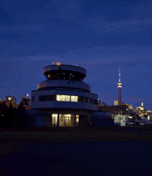 a control tower with a toronto tower in the background