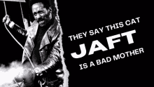 a black and white photo of a man holding a sign that says " they say this cat jaft is a bad mother "