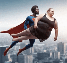 a man in a superman costume is holding a woman in a black dress