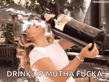 a woman drinking from a bottle of plum wine