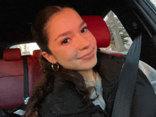 a woman sitting in the back seat of a car