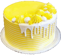 a yellow and white cake with yellow frosting and white frosting dripping down the side