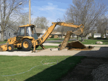 a yellow case backhoe is digging a hole