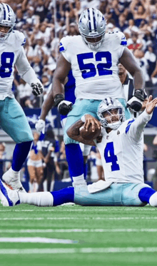 cowboys player number 4 is laying on the ground