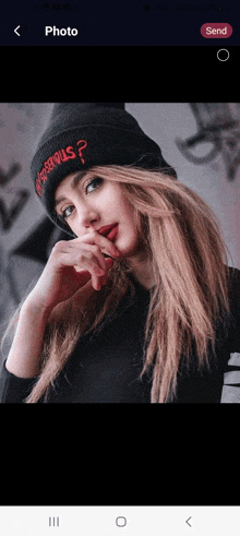 a woman wearing a beanie that says " dangerous " on it