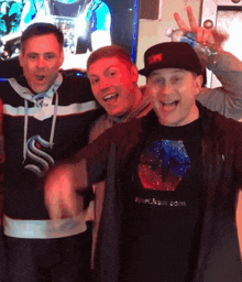 three men are posing for a picture and one of them is wearing a shirt that says risechain.com on it