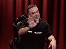a man wearing a shirt that says not famous