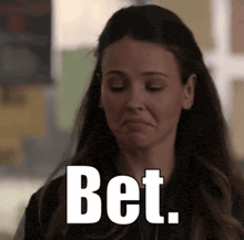 a woman is making a funny face with the words bet written on her face .