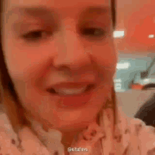 a close up of a woman 's face making a funny face in a restaurant .