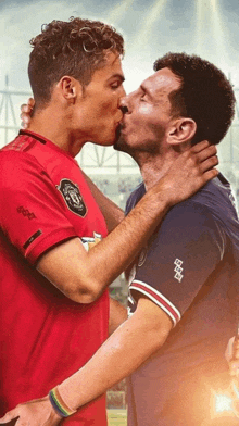 two soccer players kissing with one wearing a shirt that says manchester united