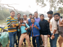 a group of young men pose for a picture with one wearing a shirt that says es