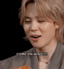 a close up of a person with the words come on wing