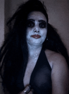 a woman with black hair and white face paint