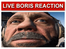 a close up of a man 's face with a live boris reaction sign above him