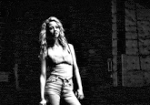 a black and white photo of a blonde woman with curly hair