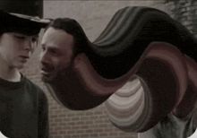 two men standing next to each other with a swirl of hair coming out of their heads