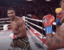 a man in a boxing ring wearing a pair of boxing gloves with a flame pattern