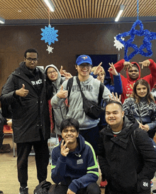 a man wearing a blue jays hat is surrounded by other people