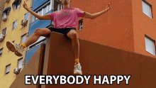 a man in a pink shirt is sitting on a wall with the words " everybody happy " above him