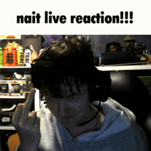 a man wearing headphones is giving the middle finger in front of a sign that says nait live reaction !!!