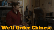 a man talking to a woman in a kitchen with the words we 'll order chinese on the bottom