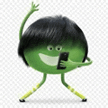 a green cartoon character is holding a cell phone and smiling .