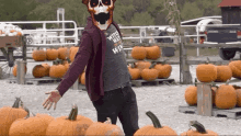 a man wearing a skeleton mask and a shirt that says ' wife 's hat ' on it