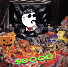 a man is sitting in a chair surrounded by candy including reese 's