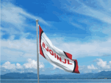 a flag that says #join jl is flying in the wind