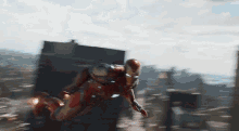 a man in a red iron man suit is flying through the air