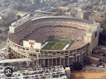 an aerial view of a football stadium with a large t on the sign