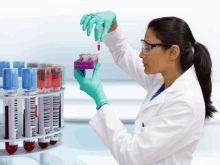 a woman in a lab coat is holding a test tube with a barcode on it