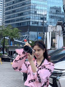 a woman taking a picture with a camera that says j.e.a.r.e.